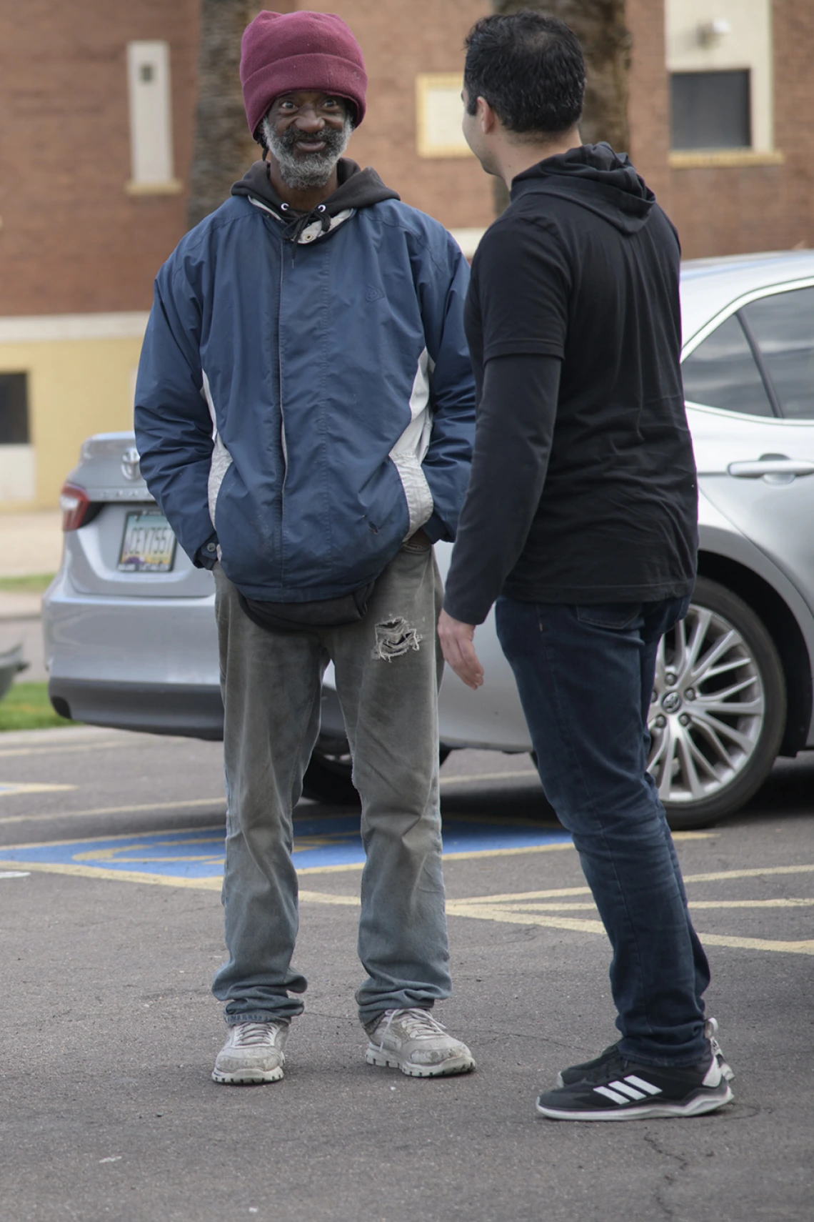 Street Medicine Phoenix co-founder Jeffery Hanna speaks with a patient outside of Grace Lutheran Church.