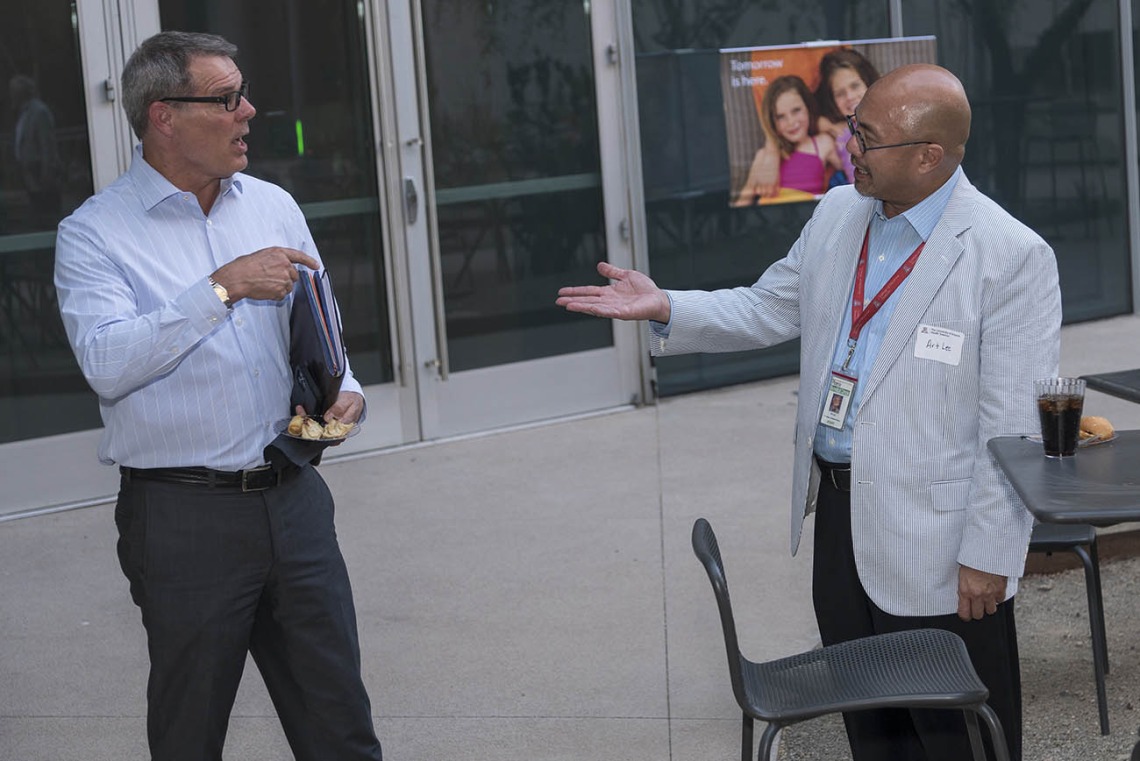 (From left) Craig Woods, DVM, MS, MBA, director of Infectious Disease and Biosecurity Projects at Arizona State University, and Art Lee, JD, vice president and deputy general counsel for UArizona, visit after the UArizona Health Sciences Tomorrow is Here Lecture Series in Phoenix. 