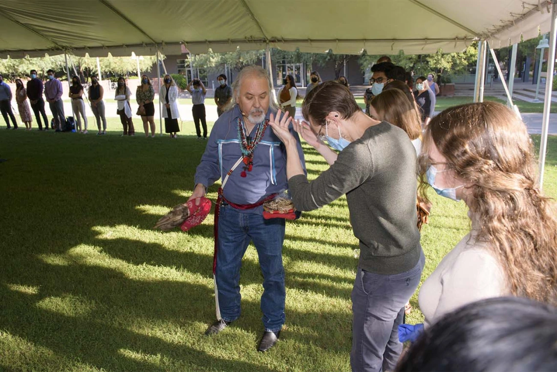 During the smudging ceremony, Dr. Carlos Gonzales blesses each individual student, faculty and staff member present. 