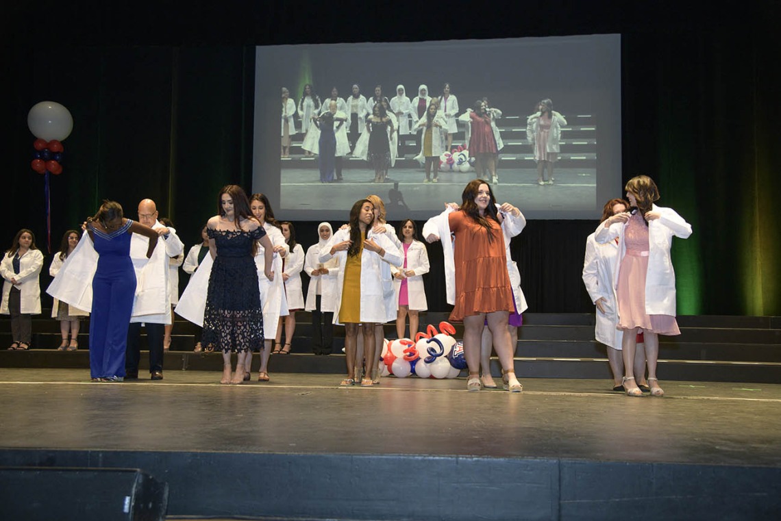 Members of the R. Ken Coit College of Pharmacy class of 2023 receive their white coats during a ceremony at Centennial Hall.  