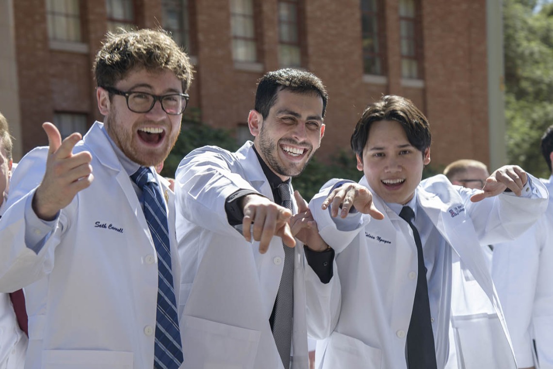 Class of 2023 R. Ken Coit College of Pharmacy students (from left) Seth Carroll, David James Caddick and Kelvin Nguyen, ham it up for a photo as they leave Centennial Hall after their white coat ceremony.