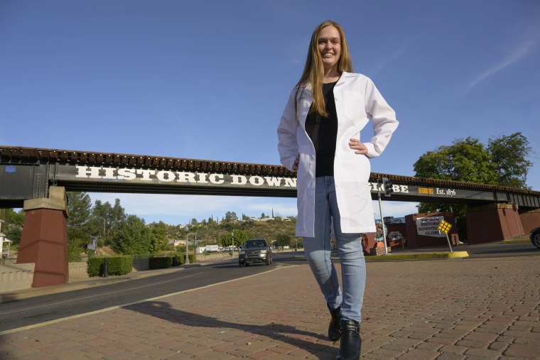 Emma Rautenberg, a first-year medical student at the University of Arizona College of Medicine – Tucson stands in front of a bridge in Globe, Arizona.