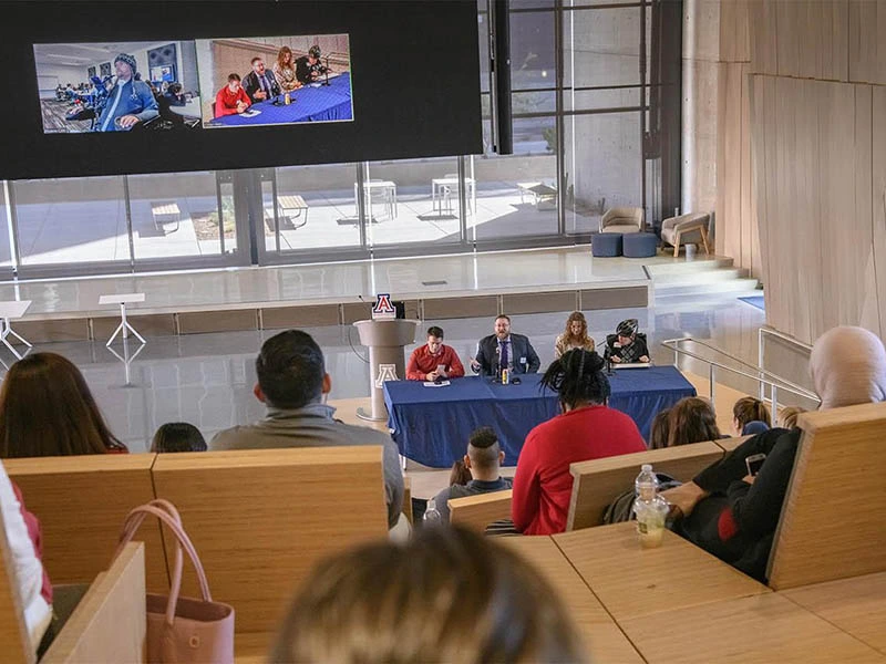 full auditorium watching a presentation