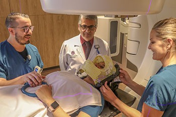 Baldassarre Stea, MD, PhD, (center), treats brain tumors with DNA-damaging radiation. (Photo: Anna C. Christensen)