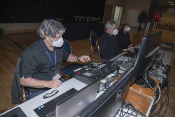 Bergeron (left), Bernard (center) and information technology support center specialist Denise Leahy (right) provide AV support at the College of Medicine – Tucson Class of 2024 White Coat Ceremony in February.