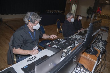 Bergeron (left), Bernard (center) and information technology support center specialist Denise Leahy (right) provide AV support at the College of Medicine – Tucson Class of 2024 White Coat Ceremony in February.