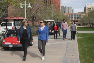 Two women walk on the Tucson Health Sciences campus