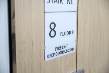 Sign on door indicating "Floor 8, Fire Exit, Keep Door Closed."