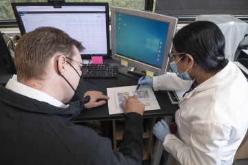 Dr. Karnes (left) and research labratory manager Kasturi Banerjee, PhD, analyze data from DNA sequencing in their lab.