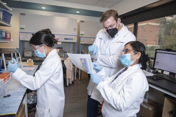 (From left) Carol Chen, a high school student participating in the BIO5 Institute's Keep Engaging Youth in Science Research Internship Program, gains first-hand research experience while assisting Drs. Karnes and Banerjee.