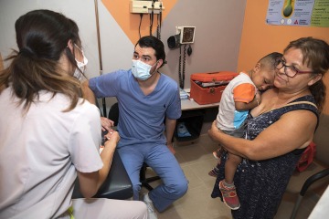 University of Arizona College of Medicine—  Phoenix student Jorge Gonzalez consults with a patient’s family at the Rocky Point Medical Center.