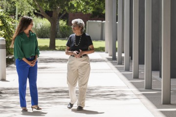 Velia Leybas Nuño, PhD, MSW, chats with her friend and former professor, Josefina Ahumada, MSW. Ahumada now leads the Adelante, Nuestro Futuro steering committee.