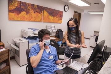 Joseph Gunderson (left) is one of the many medical students to get hands-on experience in a variety of roles at the Shubitz Family Clinic, which includes a care connections team where students function as medical social workers or case workers connecting patients with the resources they need.