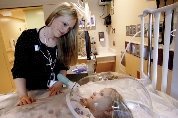Katri Typpo, MD, oversees a patient in the pediatric intensive care unit in this archival photo from 2013.