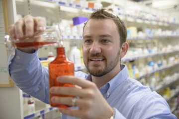 Pharmacy student mixing and dispensing medication at the University of Arizona Cancer Center.