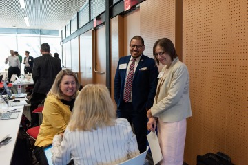 Attendees mingle at the 2019 Summit on Discovering New Drugs in Arizona. Facing camera, from left: Lori Stratton, director of development for Steele Children’s Research Center; Omar Contreras, program director, Cancer Center research; Joann Sweasy, PhD, Cancer Center director.