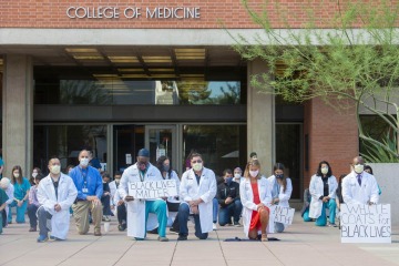 Dozens of physicians and trainees with the College of Medicine – Tucson participated in a White Coats for Black Lives demonstration following the death of George Floyd in June 2020. One of the organizers, UArizona surgeon Nfonsam Valentine, MD, far right, told the Daily Wildcat, “It’s finally a recognition of the ongoing disparities and racism and lack of opportunity, and also discontent in the minority community.” (Courtesy of UArizona Department of Surgery)