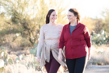 Katie DiBene (left) and her mother, Dr. Lorre Laws, PhD, enjoy a walk together.