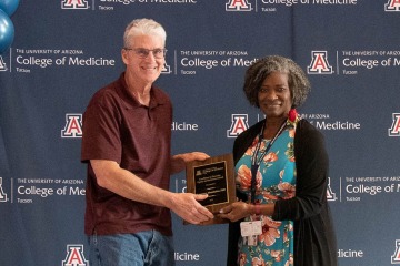 Victoria Murrain, DO, (right) the recently retired vice dean of diversity, equity and inclusion, presents the Diversity, Equity and Inclusion Excellence Award to Dr. Lawrence Mandarino.