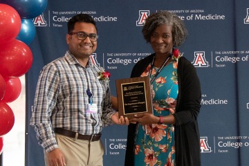Dr. Naren Patel, (left) clinical assistant professor in the Southern Arizona Limb Salvage Alliance within the Division of Vascular and Endovascular Surgery, accepts the Diversity, Equity and Inclusion Excellence Award on behalf of the Department of Surgery from Dr. Murrain.