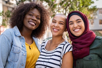 three multi-ethnic women smiling
