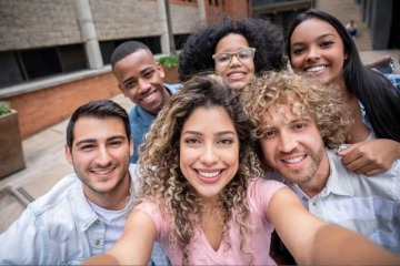 six multi-ethnic individuals smiling