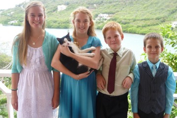 Emma Rautenberg and her three younger siblings posing for a photo in Grenada.