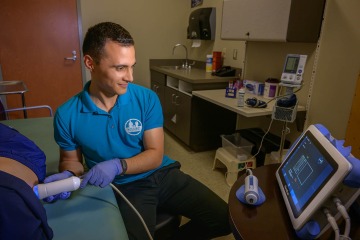 Man uses a FibroScan test on a person