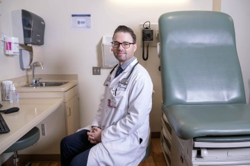 portrait of dr aaron scott in a patient room