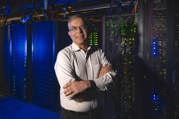 Researcher in front of supercomputer
