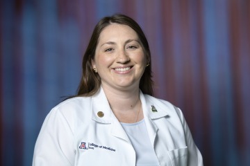 Alt Text: Dr Dawn Bowling wearing a College of Medicine – Tucson white coat