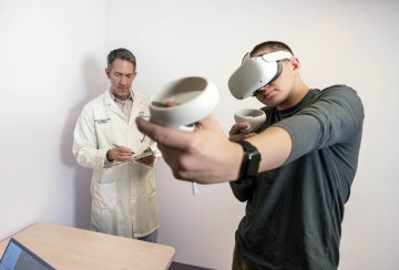 Man wearing VR headset and controller