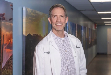 Dr. William Killgore in white lab coat in a hallway at University of Arizona Health Sciences 