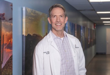 Dr. William Killgore in white lab coat in a hallway at University of Arizona Health Sciences 