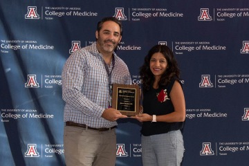 Rachna Shroff, MD, (right) interim chief of the Division of Hematology and Oncology, presents the Clinical Investigator Award to Dr. Jarrod Mosier.