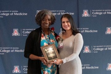 Dr. Josie G. Acuña, (right) emergency ultrasound fellow, accepts the Diversity, Equity and Inclusion Excellence Award on behalf of the Department of Emergency Medicine from Dr. Murrain.