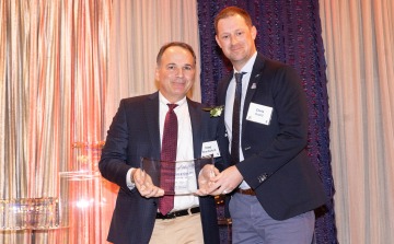 Dr. Chris Goettl stands next to Dr. Frederic Wondisford as they both hold the Alumni of the Year Award.