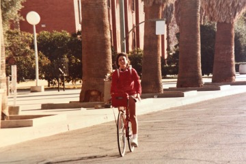 Dr. Roberta Diaz Brinton riding her bike on the University of Arizona Mall in the 1980s. 