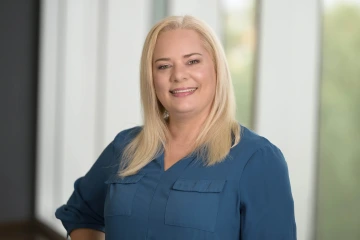 Portrait of professor Sarah Locke wearing a blue blouse and smiling