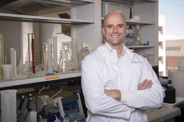 portrait of pain and addiction researcher John Streicher, PhD, in his lab at the University of Arizona Health Sciences