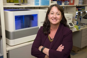 Portrait of Lisa Rimsza, MD, in a research laboratory