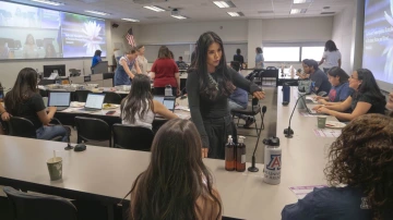 University of Arizona College of Nursing professor, Timian Godfrey, speaks to a group of nursing students in a classroom.