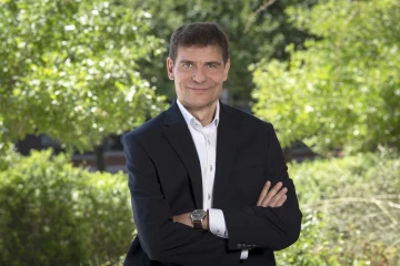 Portrait of researcher Stefano Guerra, MD, PhD, MPH, in front of a Sonoran desert landscape