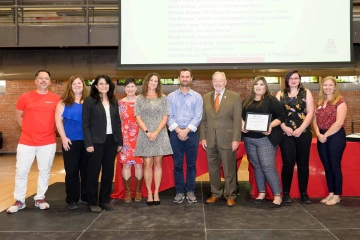 Members of the PeerWORKS and Project FUTRE team accept the Team Award for Excellence from Interim Provost Ronald Marx.