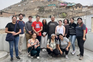 Group photo of several people and Gabriela Valdez, PhD, with the landscape of Peru in the background.