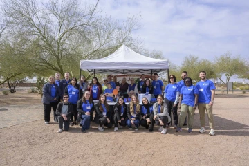 A group photo of students, staff and faculty members outside in Apache Junction, Arizona. 