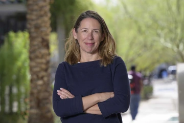 Portrait of researcher Gloria Coronado, PhD, outdoors on the University of Arizona Health Sciences campus.