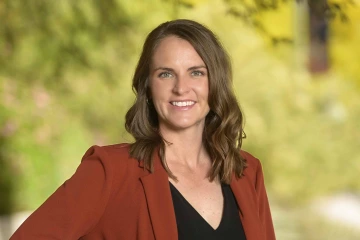 Portrait of Stephanie Gasser smiling in an outdoor setting.