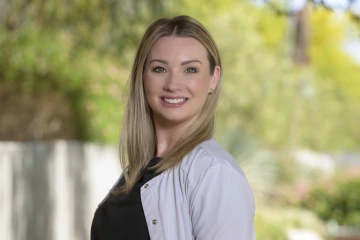 Portrait of Brooke Swonger smiling in an outdoor setting.