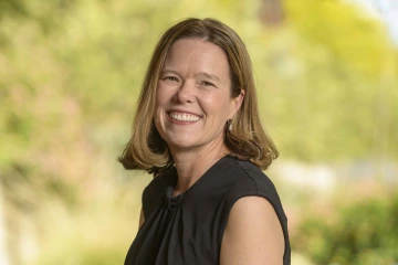 Portrait of Karin Blasko smiling in an outdoor setting.